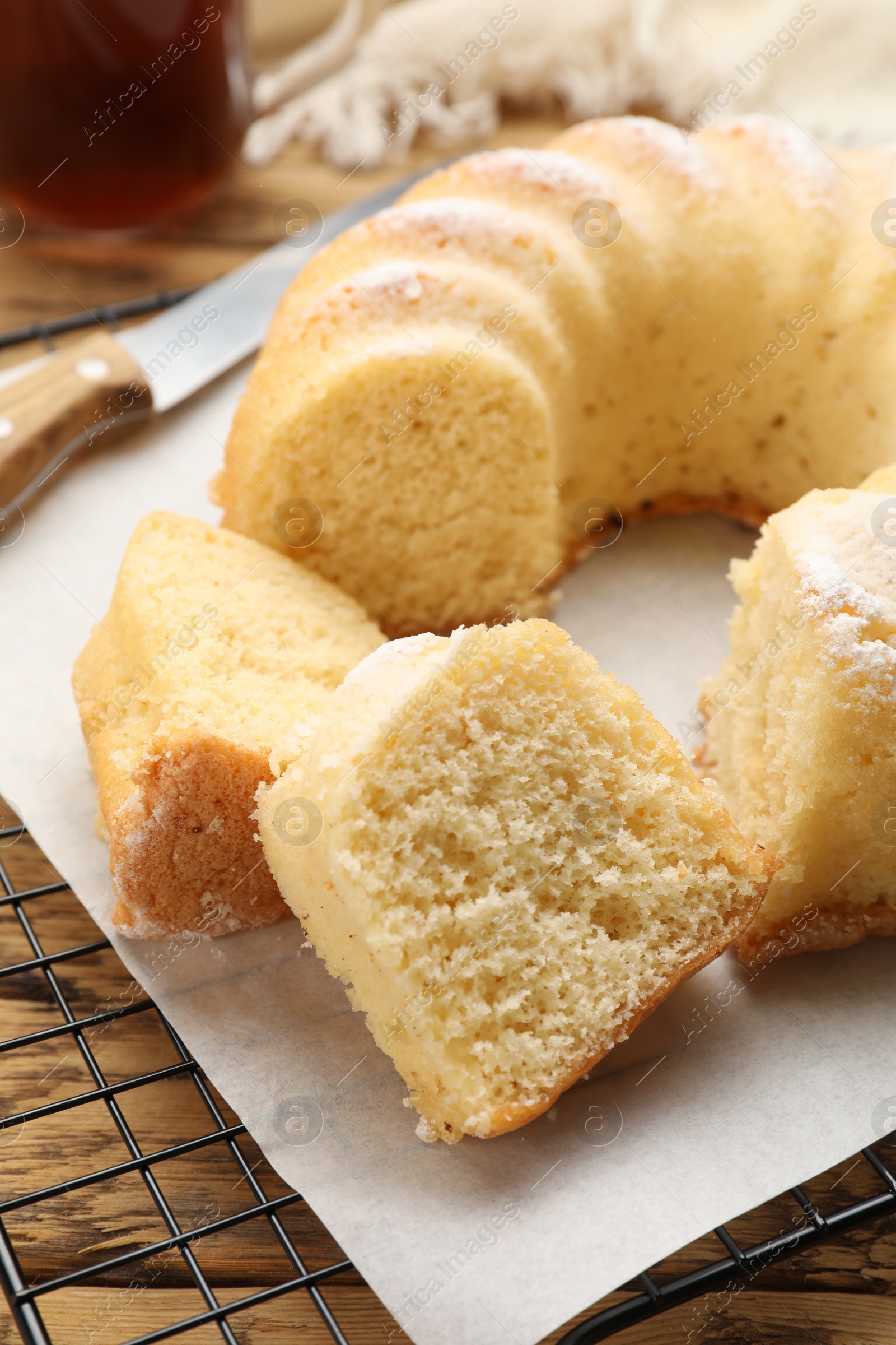 Photo of Delicious freshly baked sponge cake on wooden table, closeup