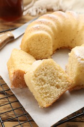 Delicious freshly baked sponge cake on wooden table, closeup