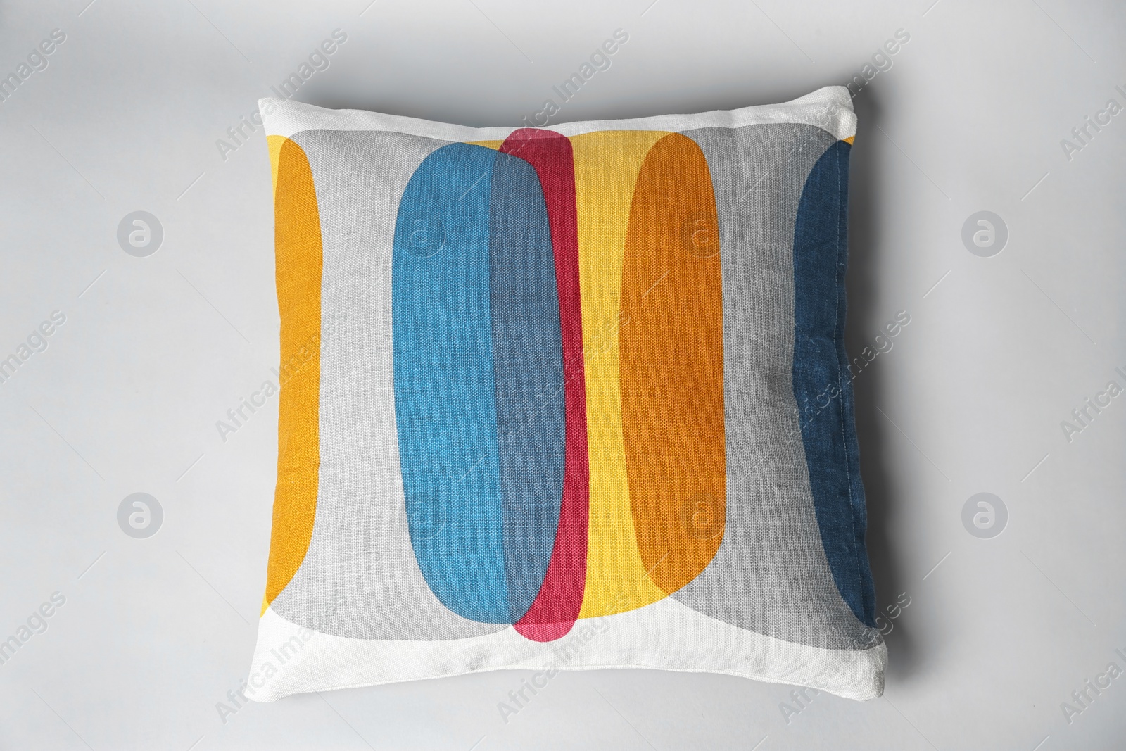 Photo of Soft decorative pillow on light background