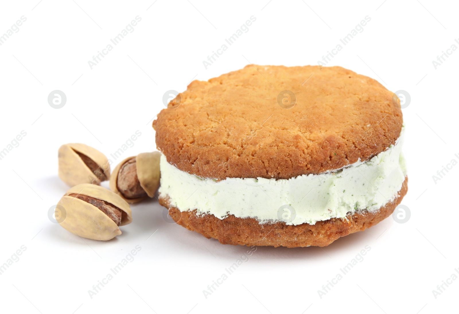 Photo of Sweet delicious ice cream cookie sandwich and pistachios on white background