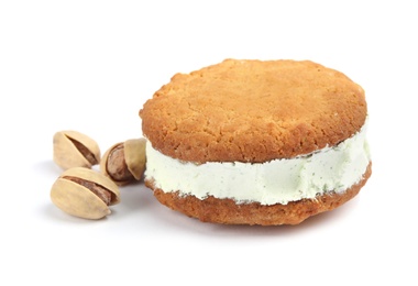 Photo of Sweet delicious ice cream cookie sandwich and pistachios on white background