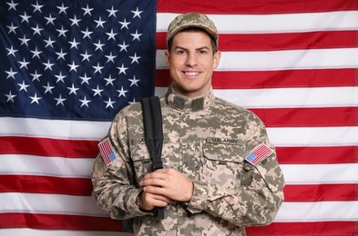 Cadet with backpack against American flag. Military education