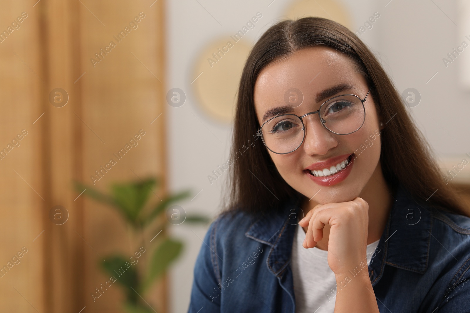 Photo of Portrait of beautiful young woman with glasses indoors, space for text. Attractive lady smiling and looking into camera