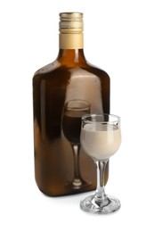 Bottle and glass of coffee cream liqueur isolated on white