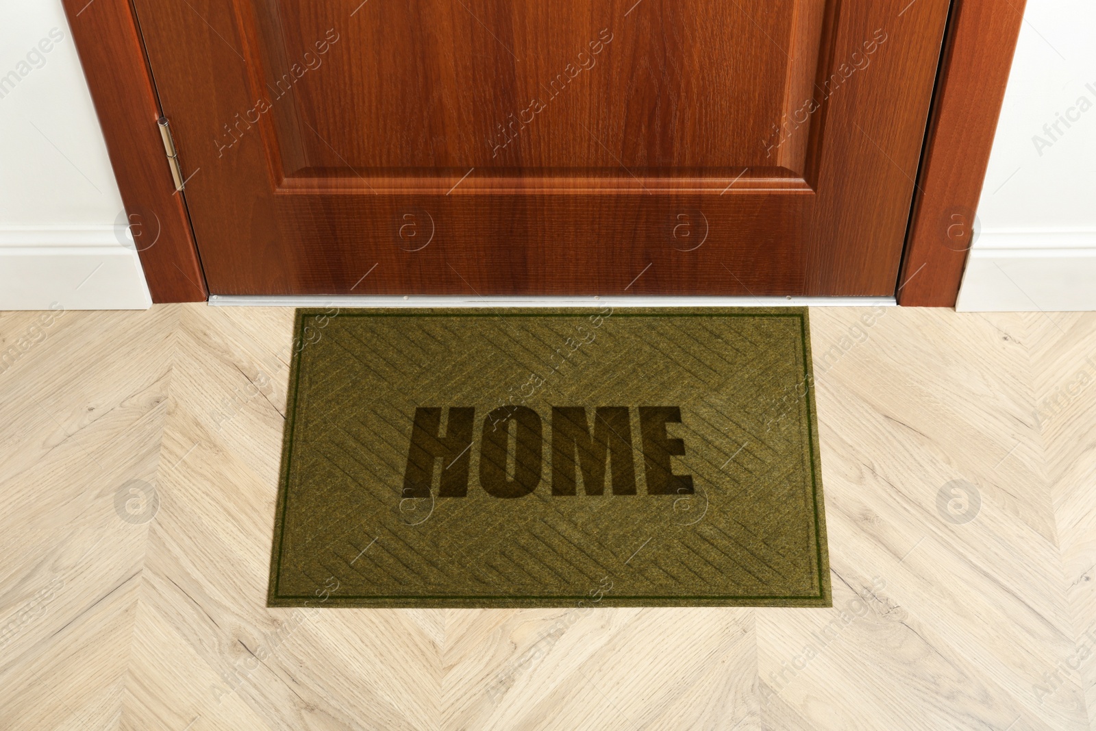 Image of Door mat with word Home near entrance door