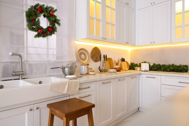 Photo of Cozy kitchen decorated for Christmas. Interior design