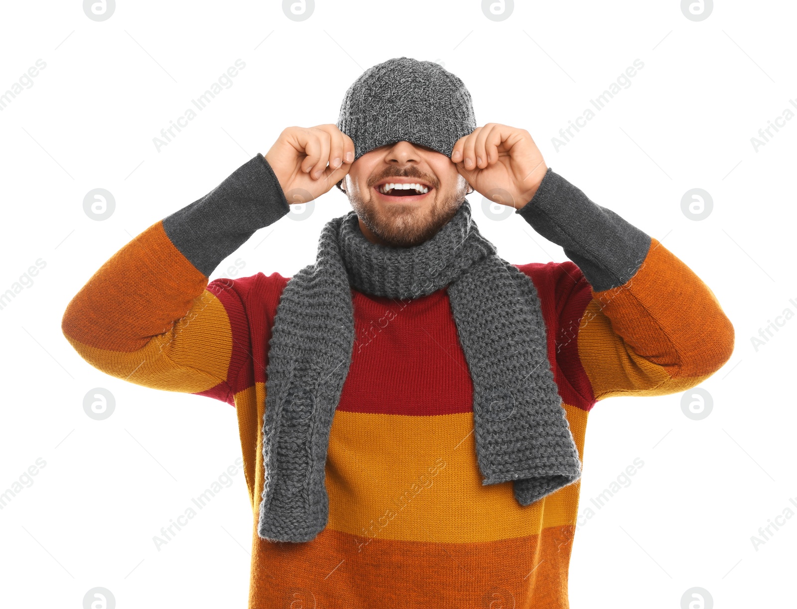 Photo of Emotional young man in warm clothes on white background. Winter vacation