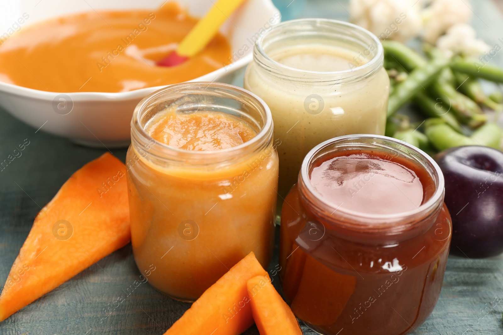 Photo of Jars with healthy baby food on table