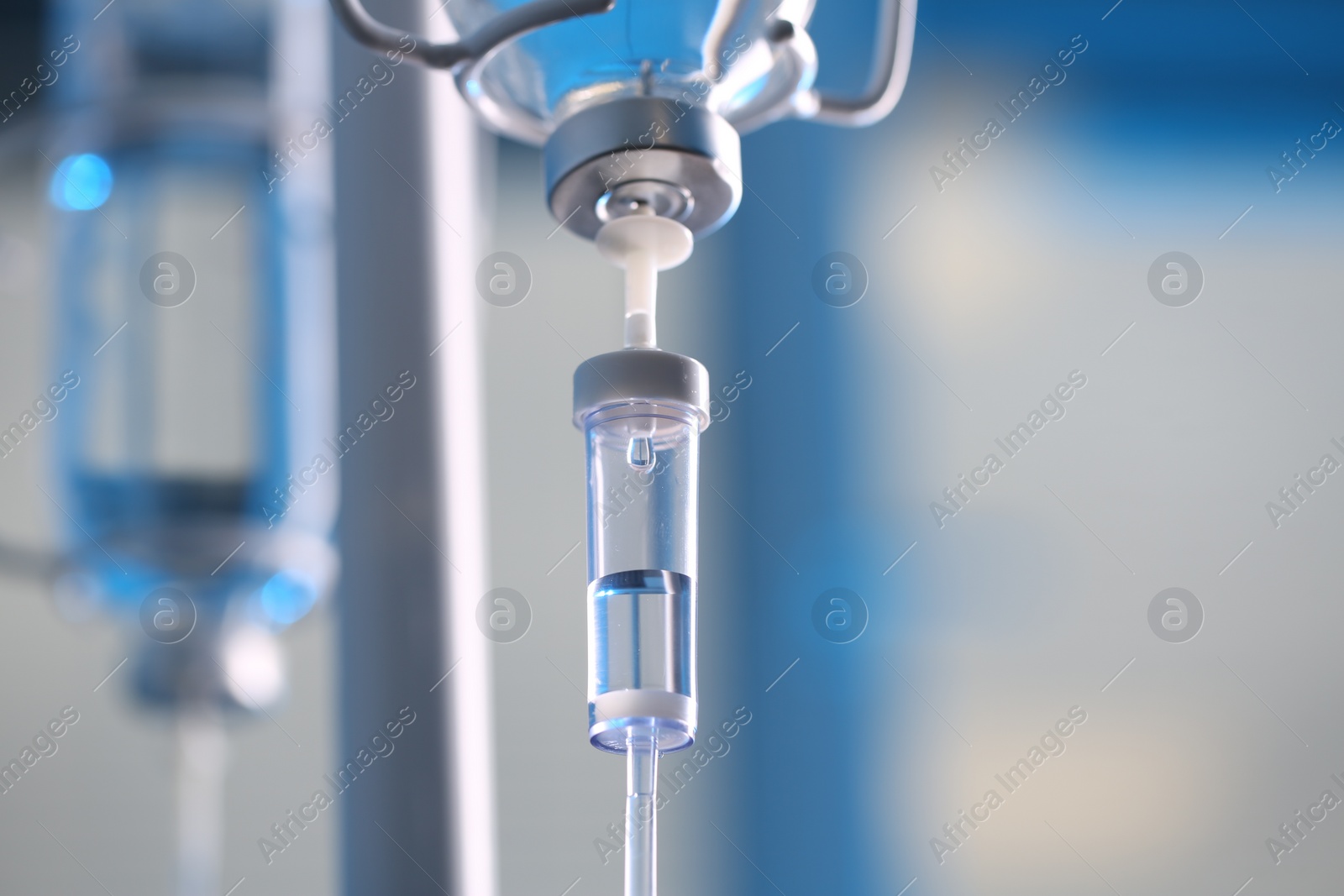 Photo of IV drip chamber against blurred light background