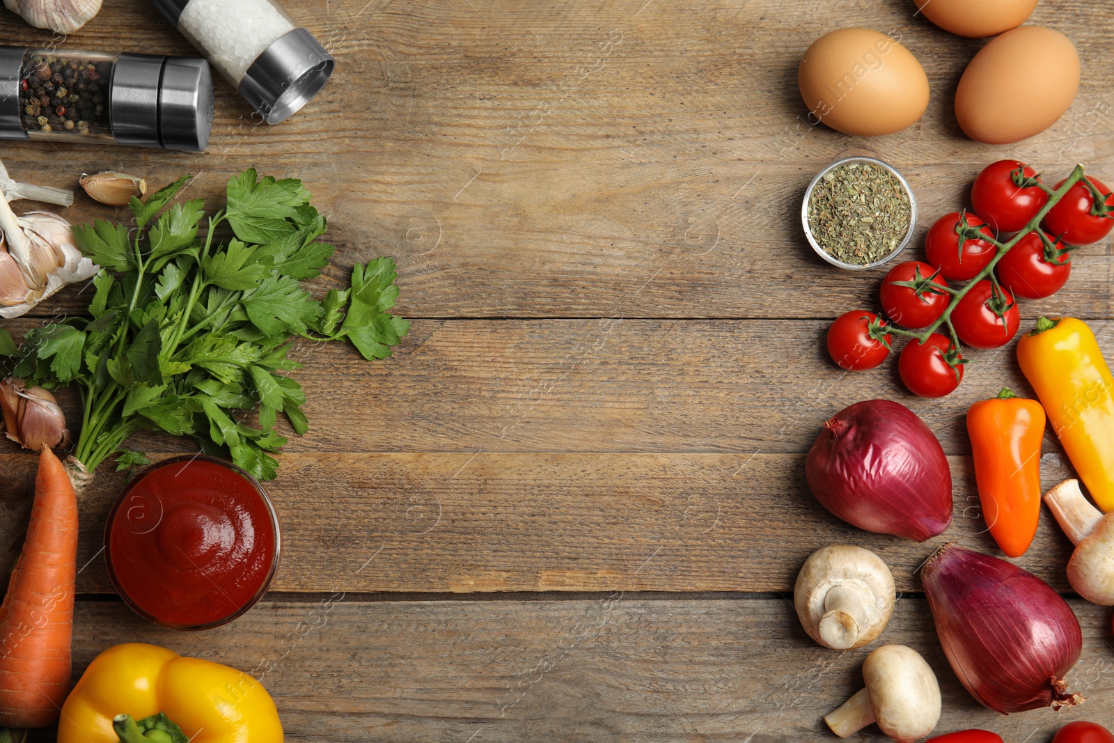 Photo of Flat lay composition with ingredients for cooking on wooden table. Space for text