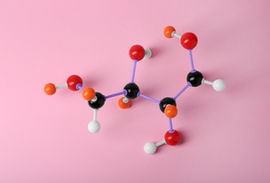 Photo of Molecule of sugar on pink background, top view. Chemical model