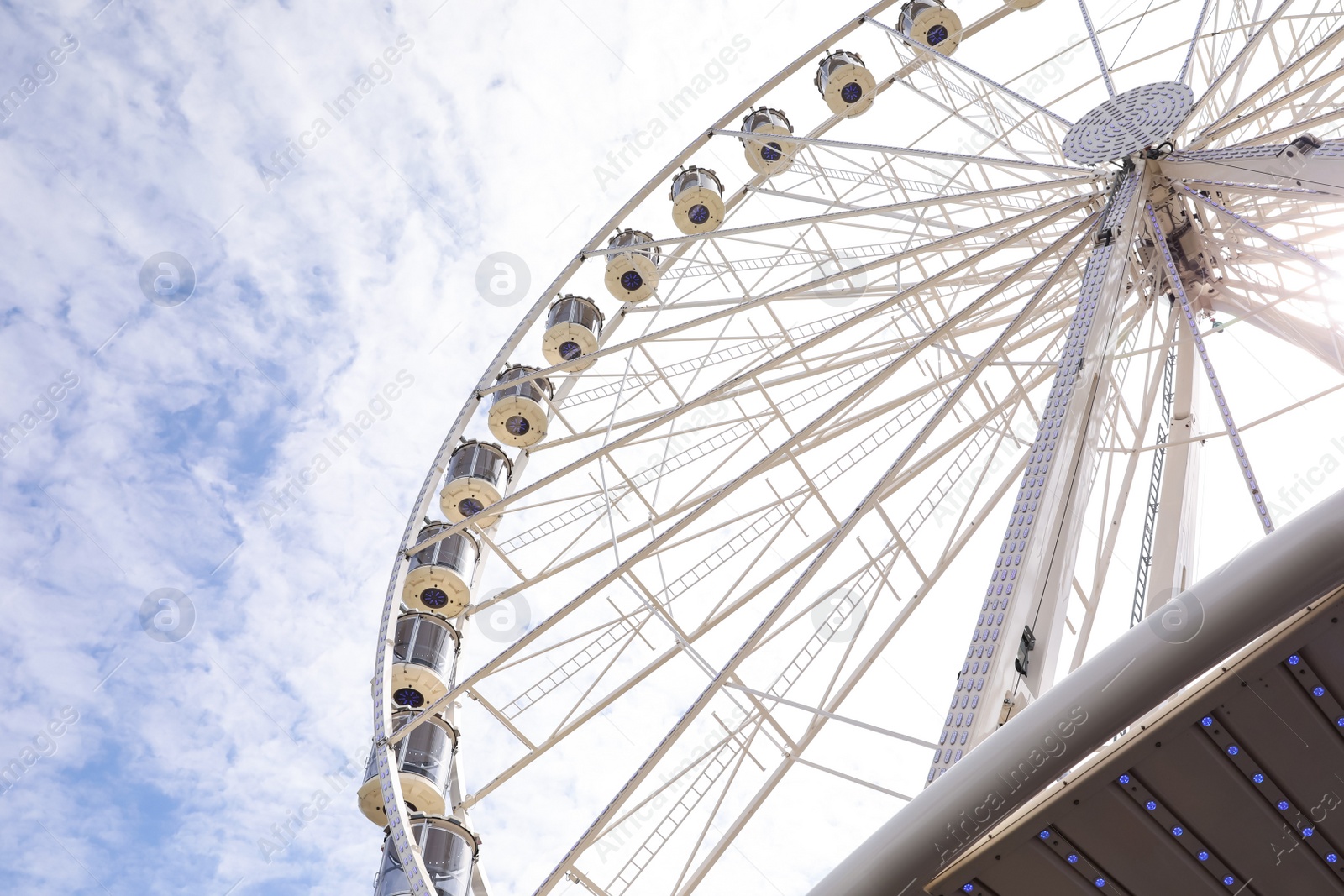 Photo of Beautiful Ferris wheel against cloudy sky, low angle view