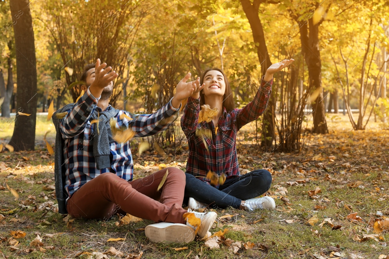 Photo of Young lovely couple spending time together in park. Autumn walk