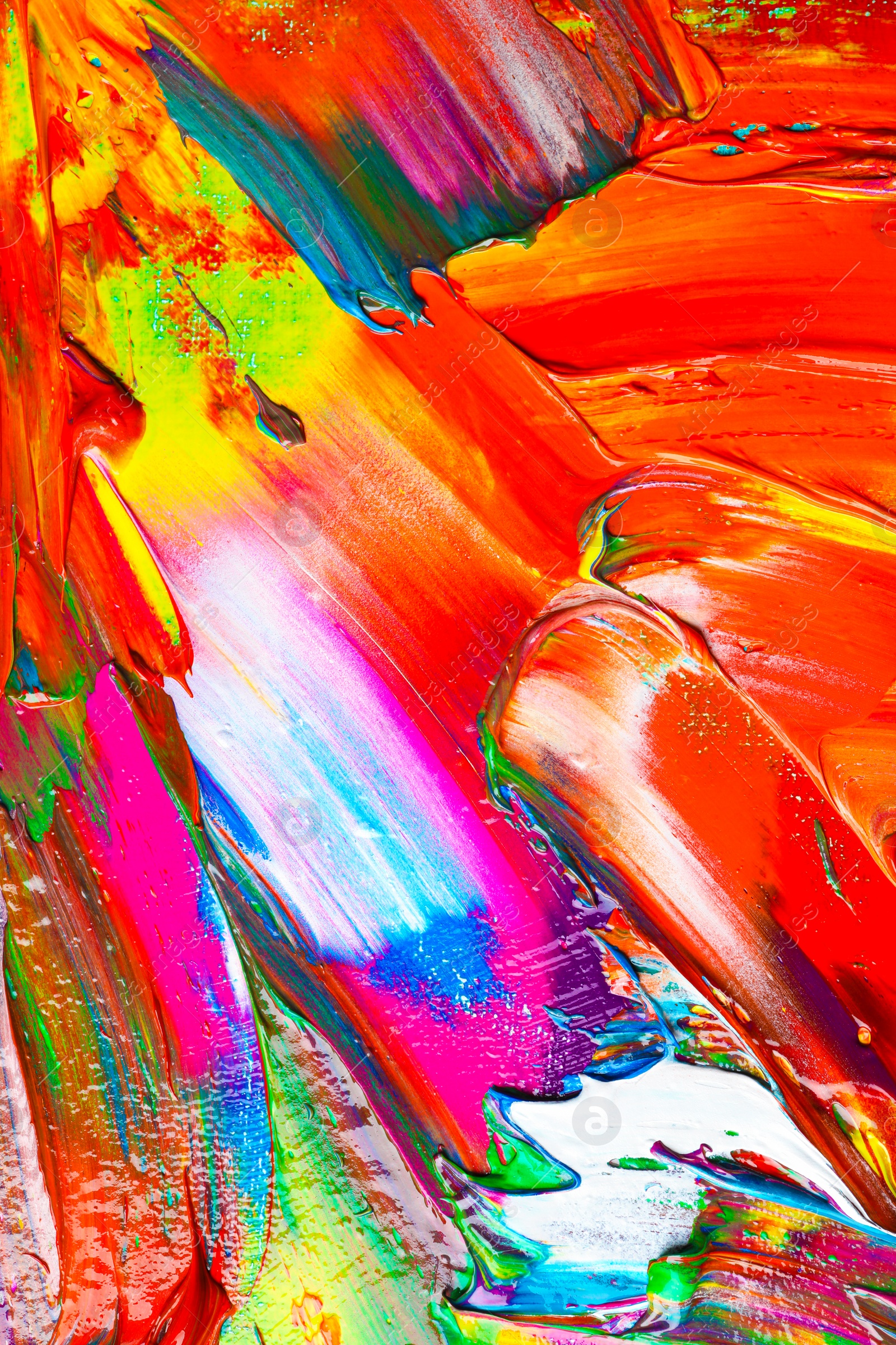 Photo of Strokes of colorful acrylic paints as background, closeup view