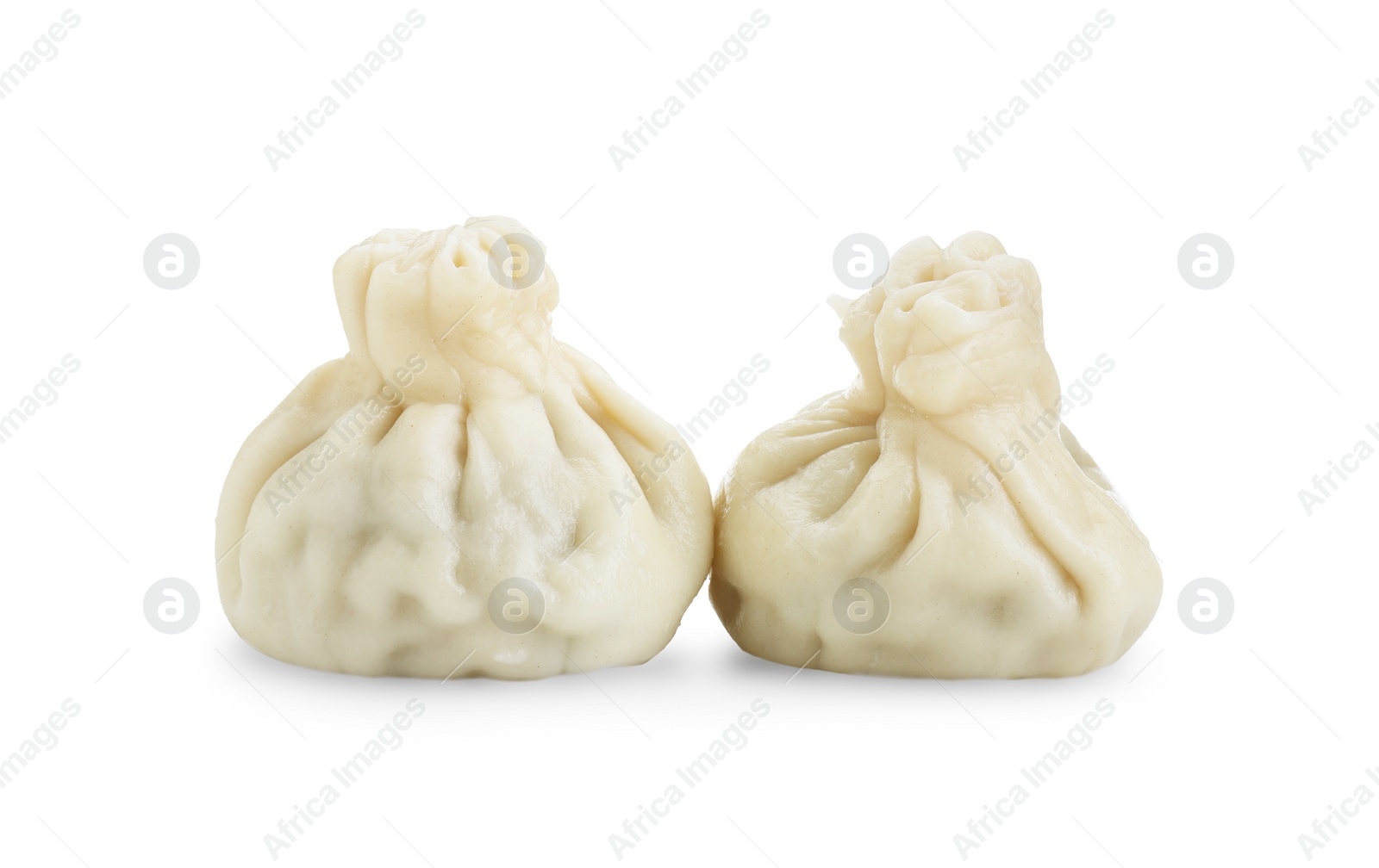 Photo of Two tasty khinkali (dumplings) isolated on white. Georgian cuisine