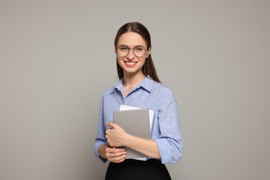 Photo of Portrait of beautiful young teacher on grey background