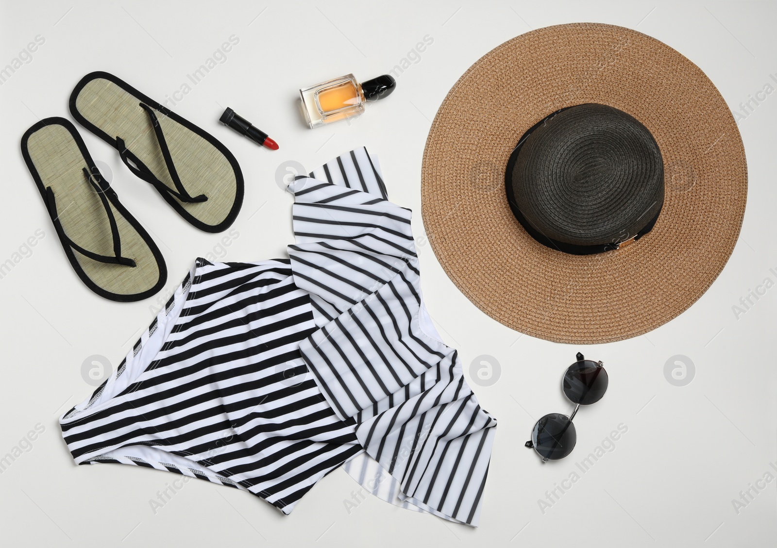 Photo of Flat lay composition with stylish beach accessories on light background