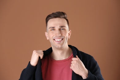 Photo of Portrait of young man with beautiful hair on color background