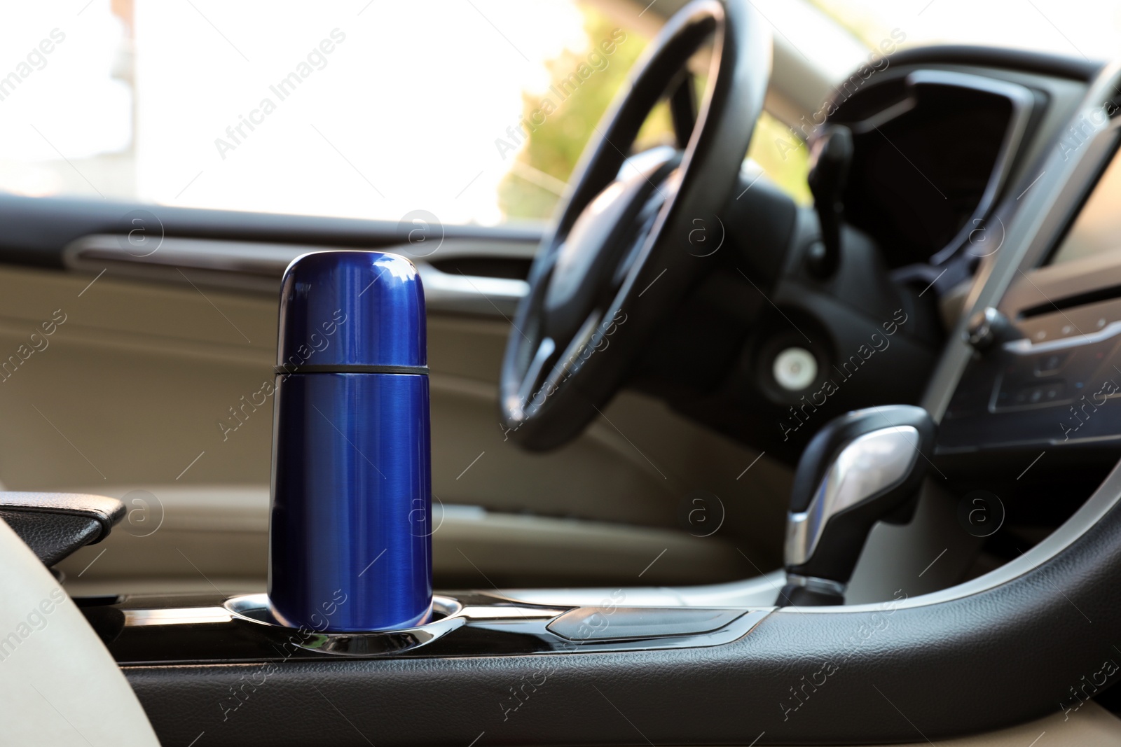 Photo of Blue thermos in holder inside of car