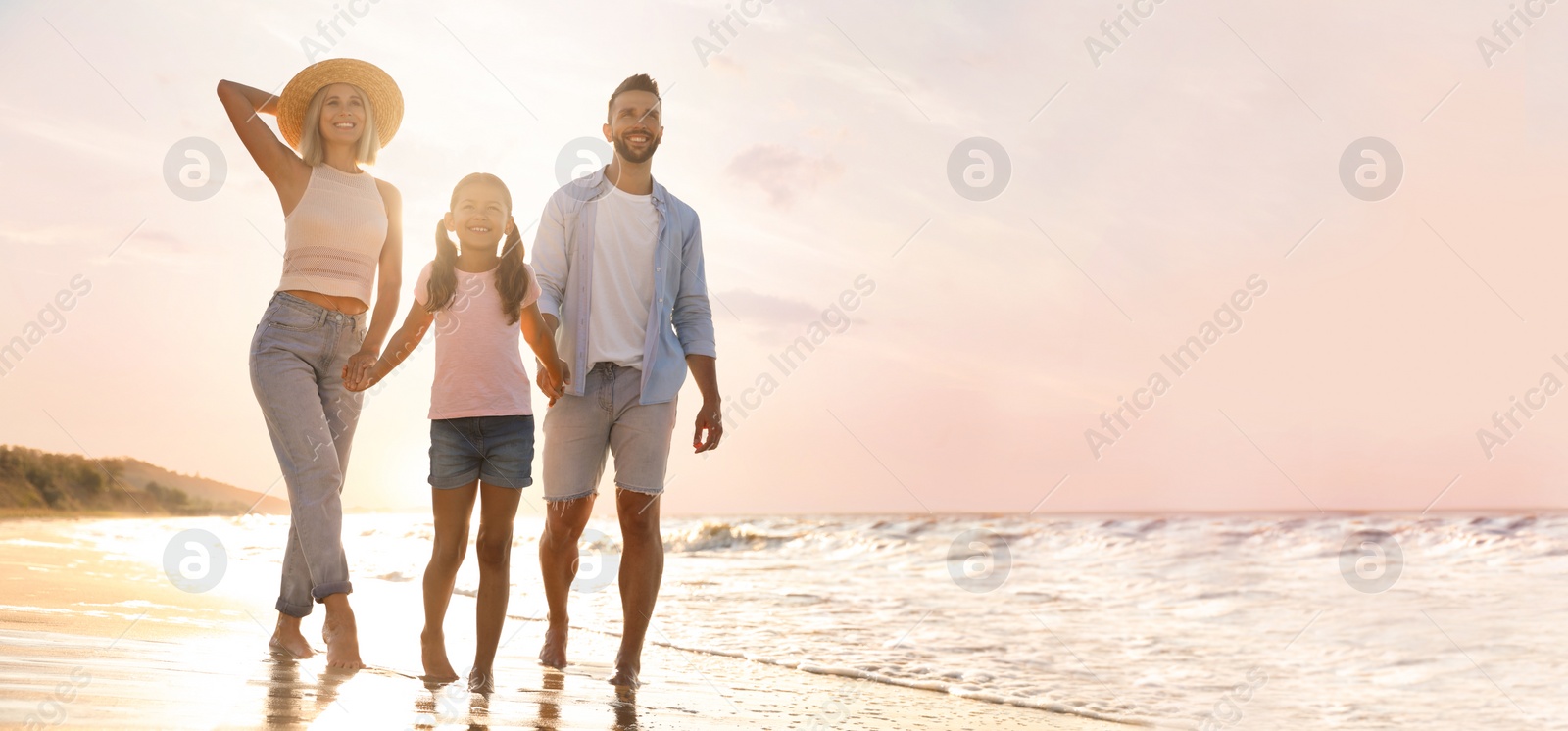 Image of Happy family on sandy beach near sea, space for text. Banner design