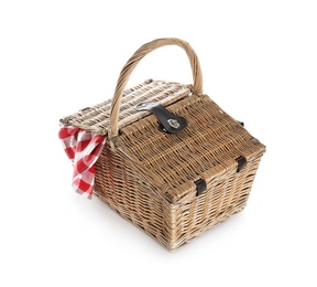 Photo of Closed wicker picnic basket with checkered blanket on white background