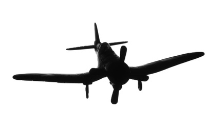 Dark silhouette of vintage toy military airplane on white background