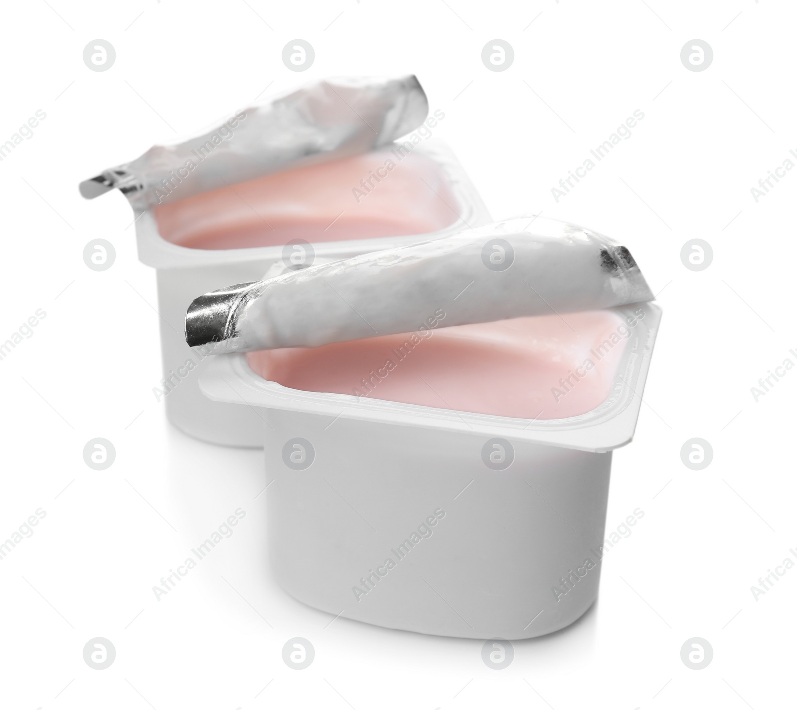 Photo of Plastic cups with yummy yogurt on white background