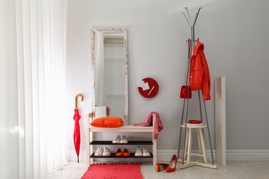 Photo of Cozy stylish hallway interior with shoe rack and mirror. Home design idea
