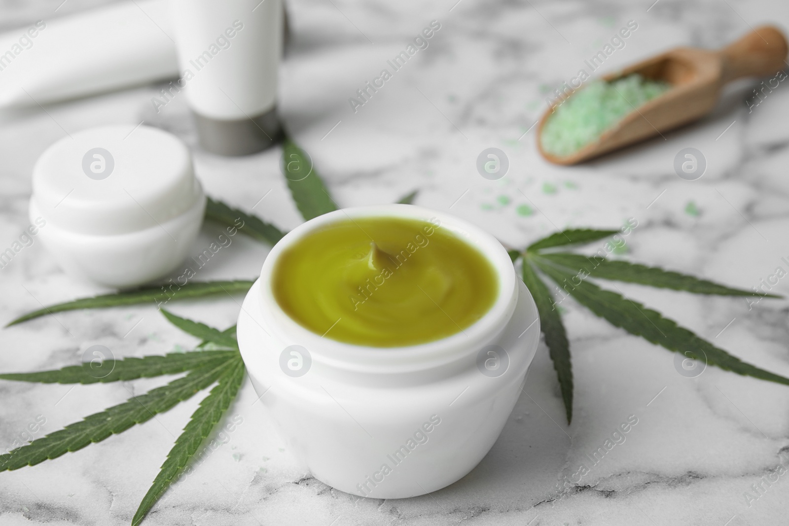 Photo of Jar of hemp cream on marble table. Organic cosmetics