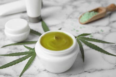 Jar of hemp cream on marble table. Organic cosmetics