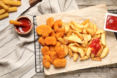 Photo of Different snacks and tasty ketchup on table, flat lay