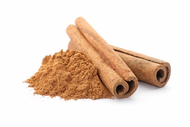 Aromatic cinnamon sticks and powder on white background