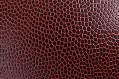 Texture of American football ball leather as background, closeup