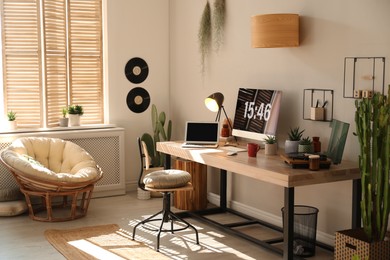 Photo of Room interior with comfortable workplace. Modern computer and laptop on wooden desk