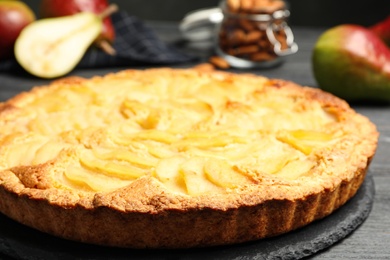 Photo of Delicious sweet pear tart on table, closeup