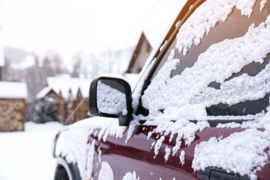 Photo of Car covered with snow after storm outdoors on beautiful winter day, closeup