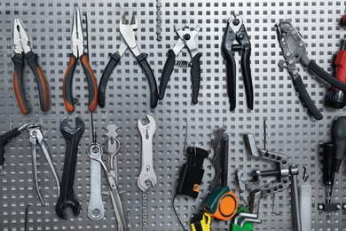 Photo of Set of different tools for bicycle repairing on stand