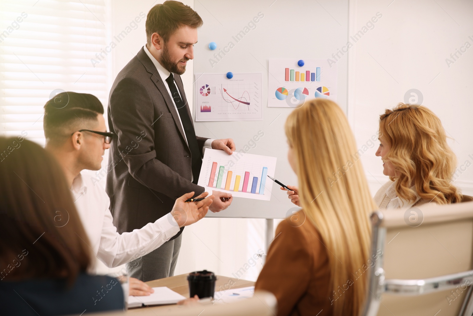 Photo of Businesspeople having meeting in office. Management consulting