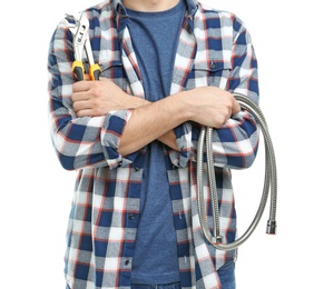 Young plumber with hose and adjustable wrench on white background