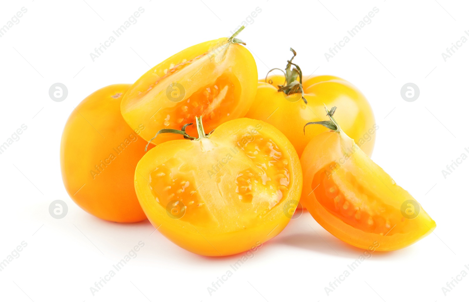 Photo of Cut and whole yellow tomatoes on white background