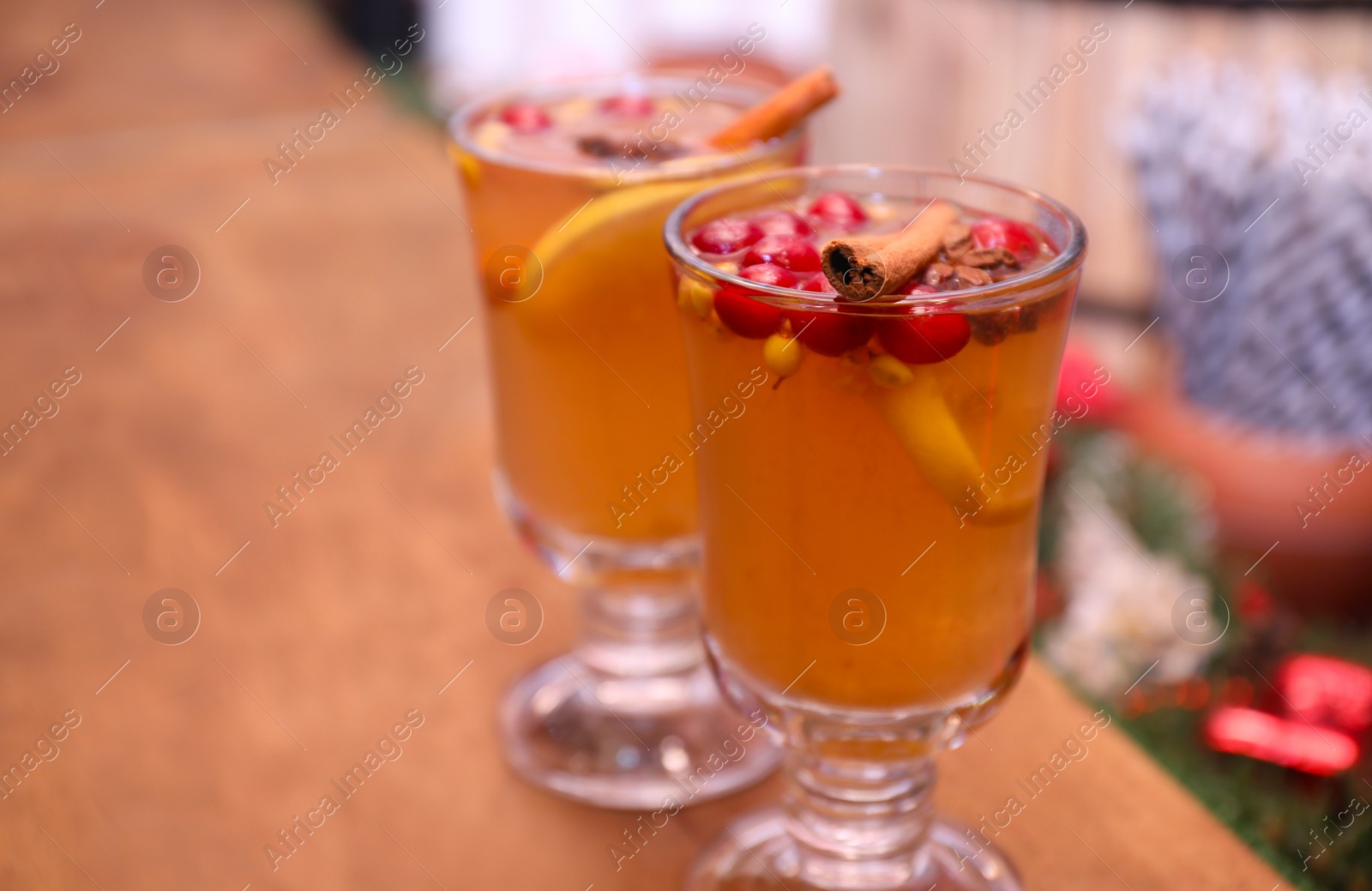 Photo of Tasty aromatic mulled wine on wooden table
