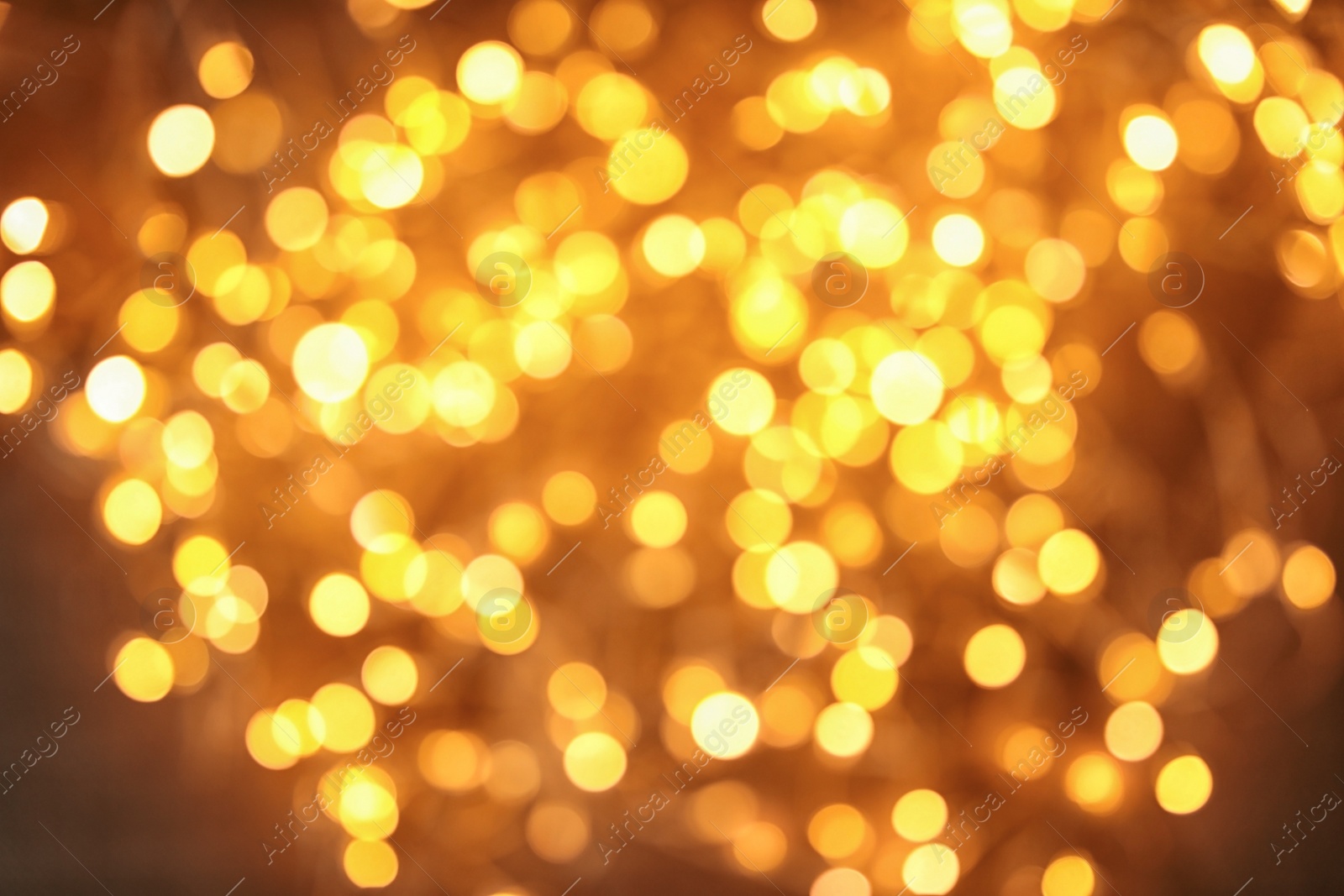 Photo of Gold glitter with bokeh effect on dark background