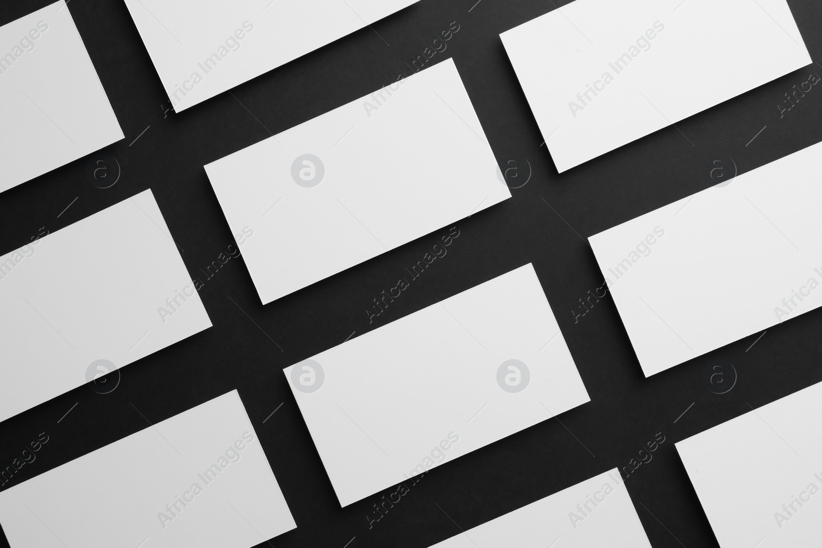 Photo of Blank business cards on black background, flat lay. Mockup for design