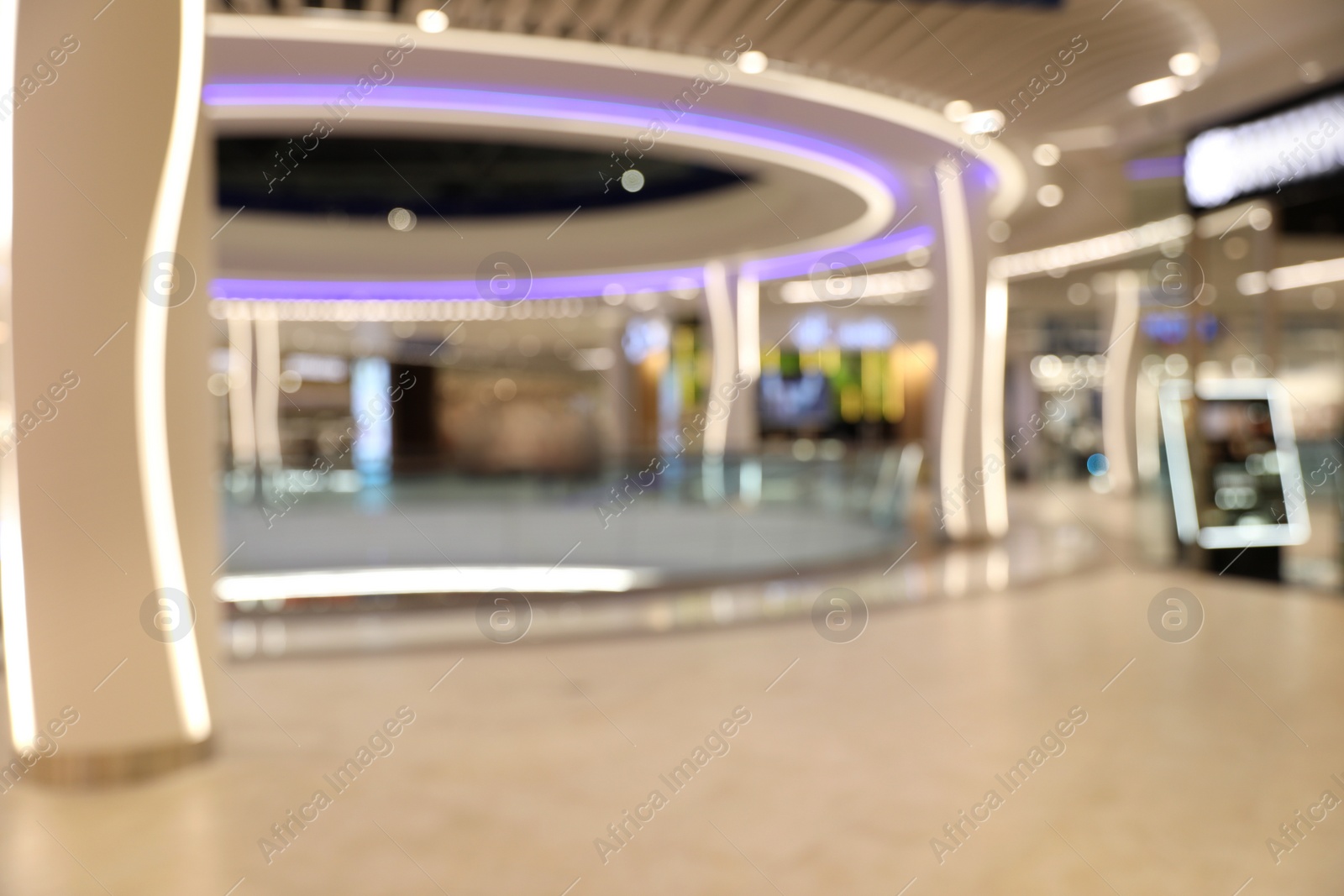 Photo of Blurred view of modern shopping mall interior. Bokeh effect