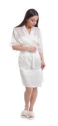 Photo of Young woman in silk robe on white background