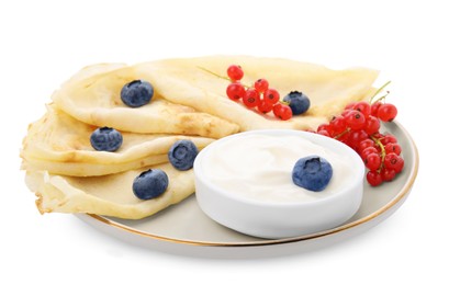 Photo of Delicious crepes with natural yogurt, blueberries and red currants on white background