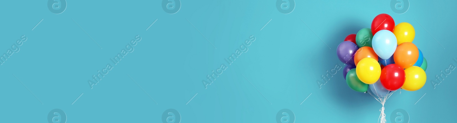 Image of Bunch of bright balloons on light blue background, space for text. Banner design 