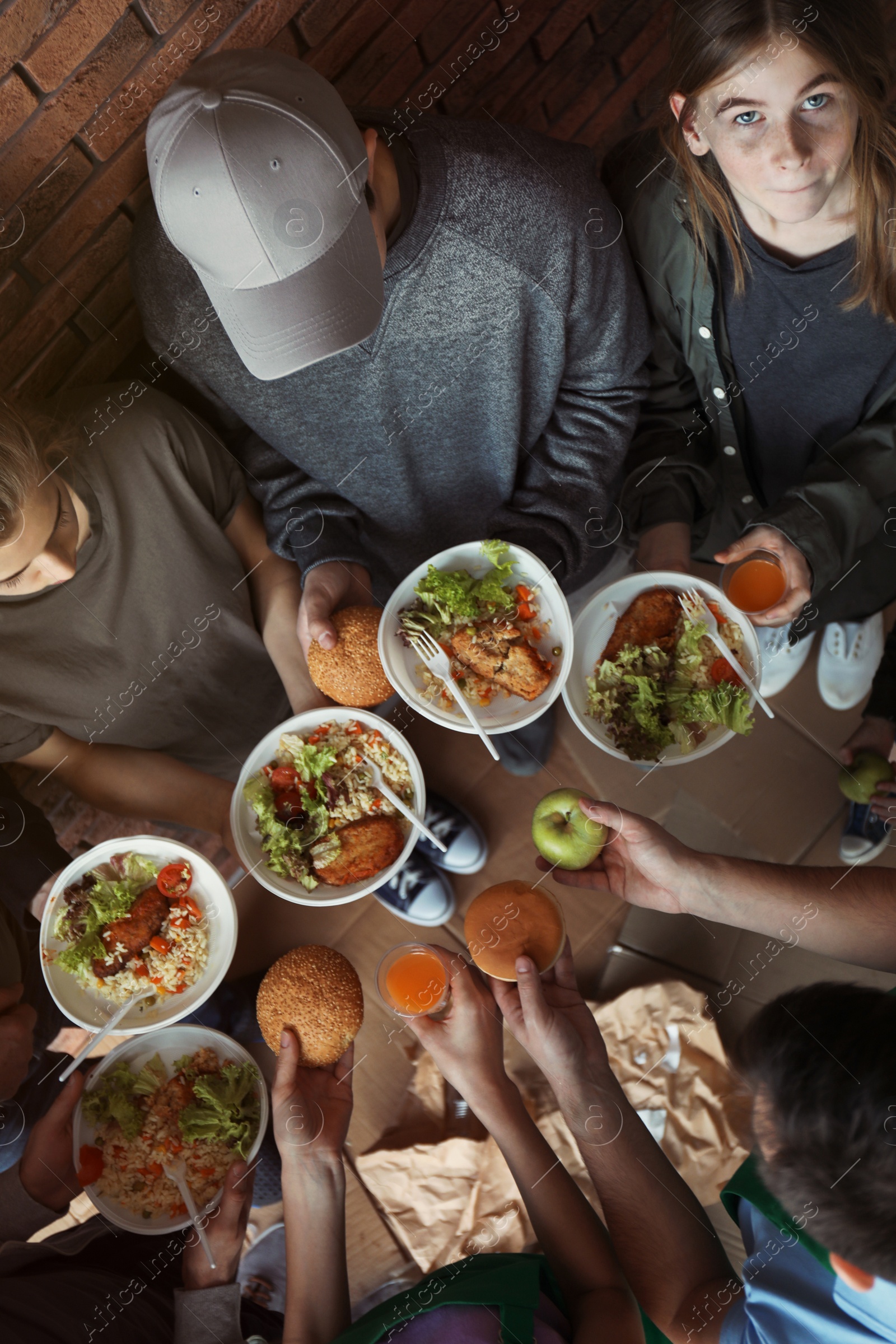 Photo of Poor people holding food indoors, view from above