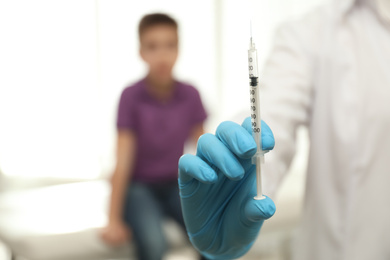 Photo of Doctor with syringe in clinic, closeup. Vaccination day