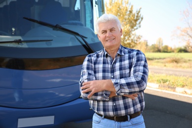 Professional driver standing near bus. Passenger transportation